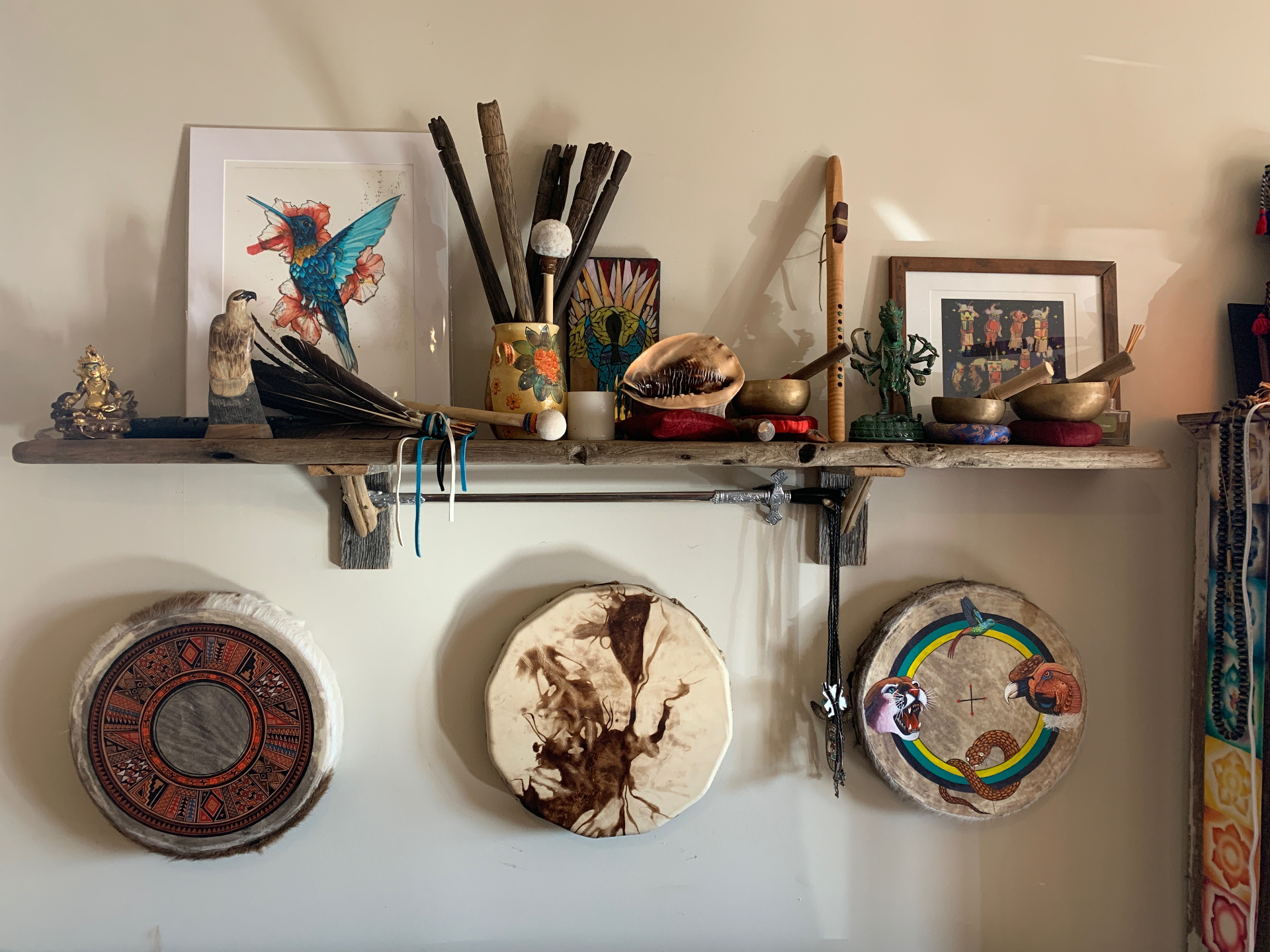 Sacred altar with shamanic drums, feathers and ceremonial objects