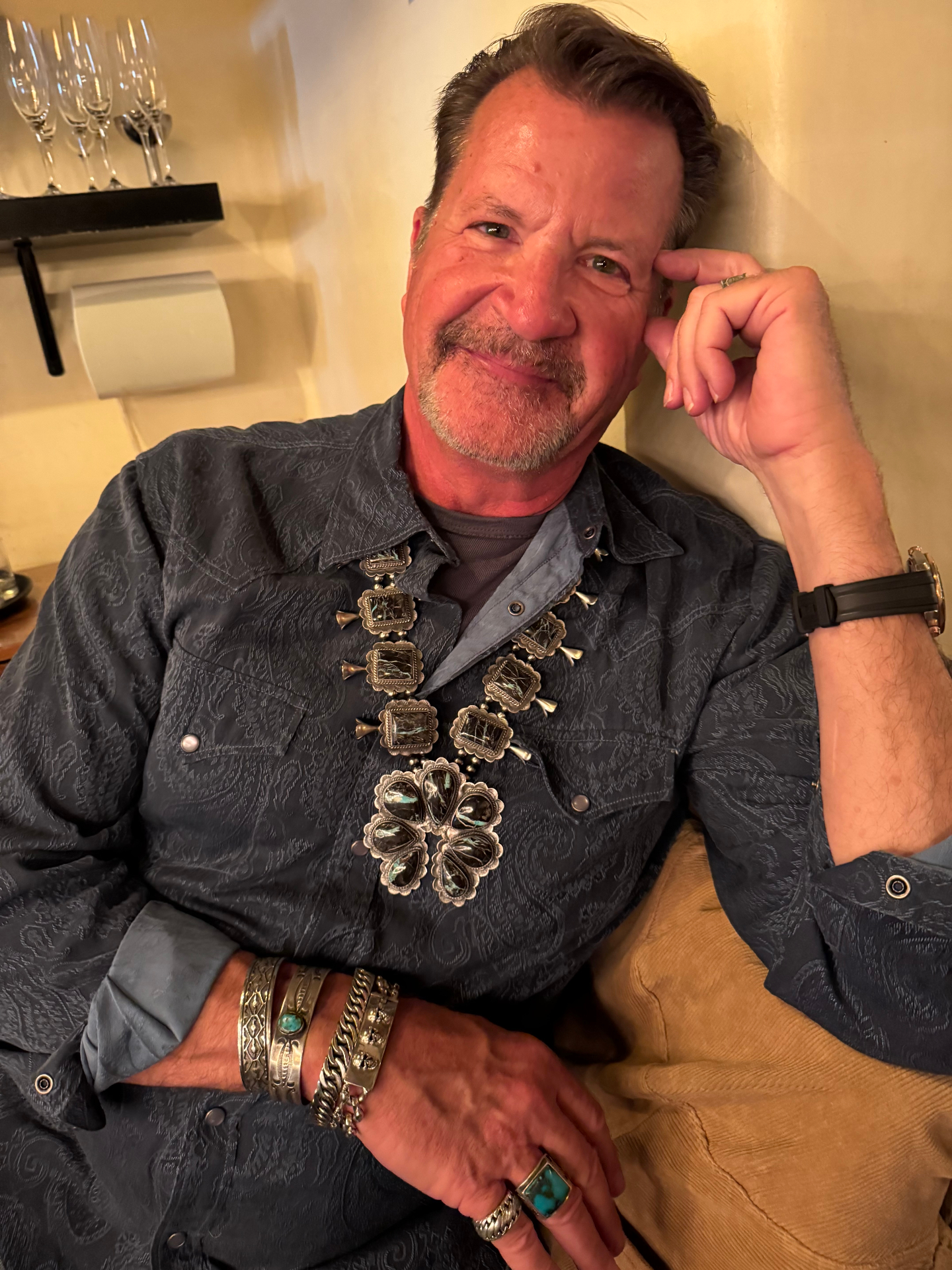 John Whitehorse wearing a Navajo squash blossom necklace