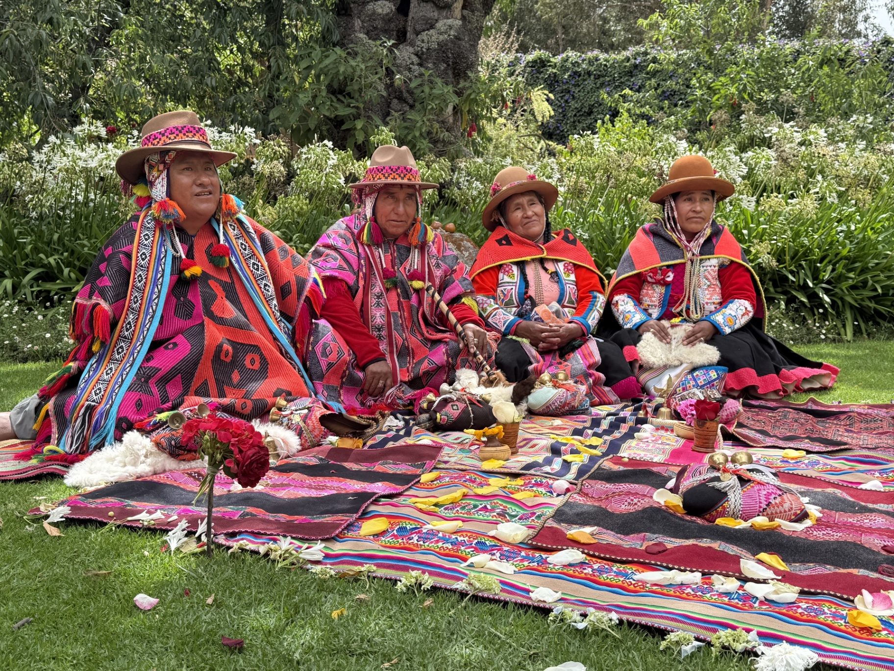 Q'ero shamans and paqos gathered on a ceremonial mesa with sacred khuyas and offerings