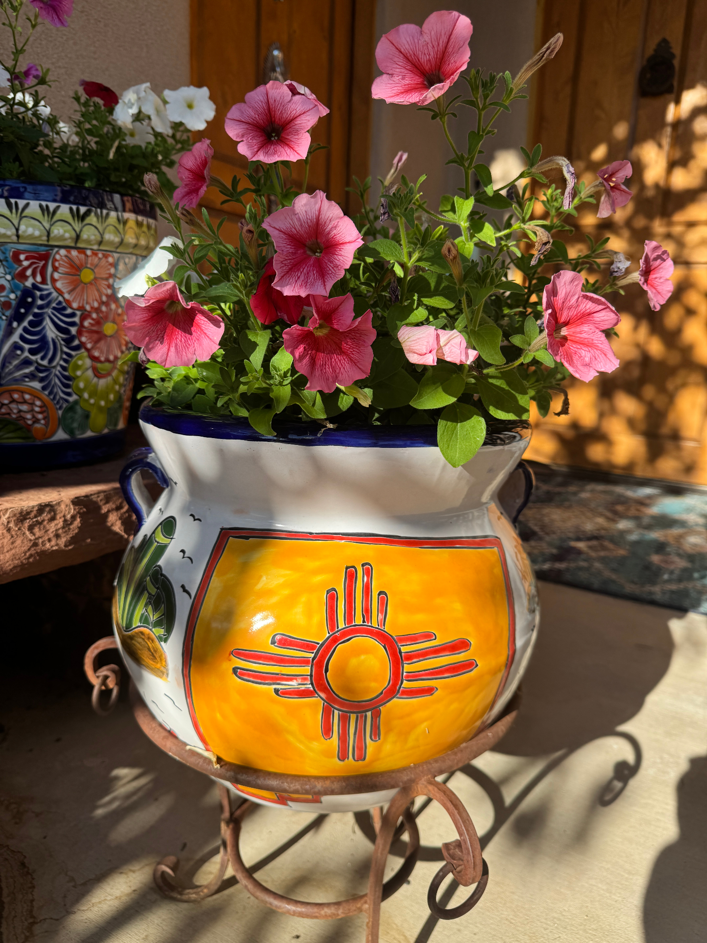 Colorful Talavera pot with pink flowers and the New Mexico Zia sun symbol in Santa Fe