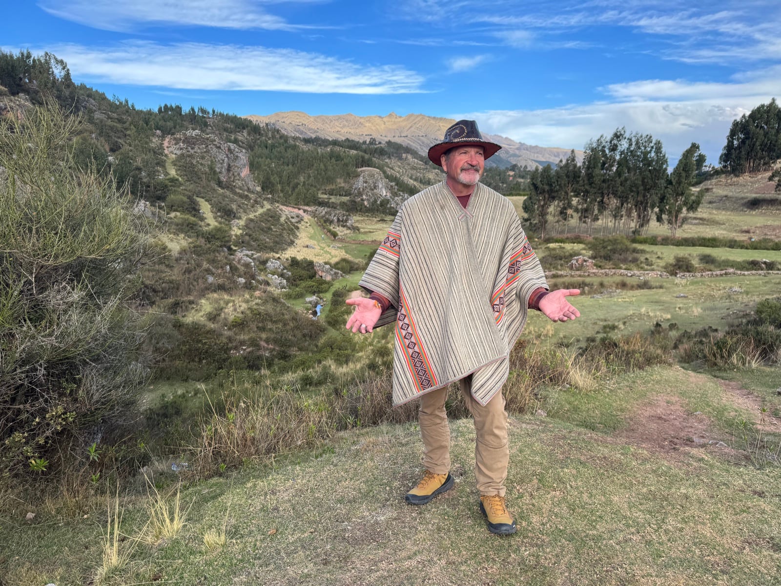 Shaman John Whitehorse arms outstretched in the High Andes - Shamanic Trekker