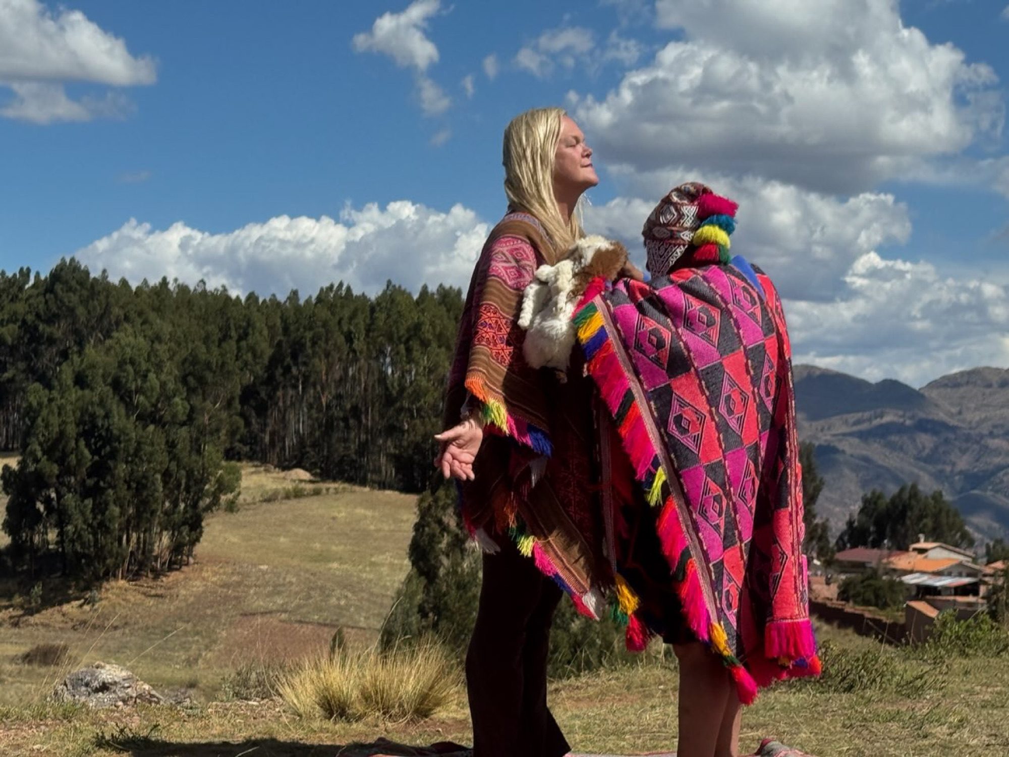 Kristen White standing alongside a Q'ero shaman overlooking the Andes