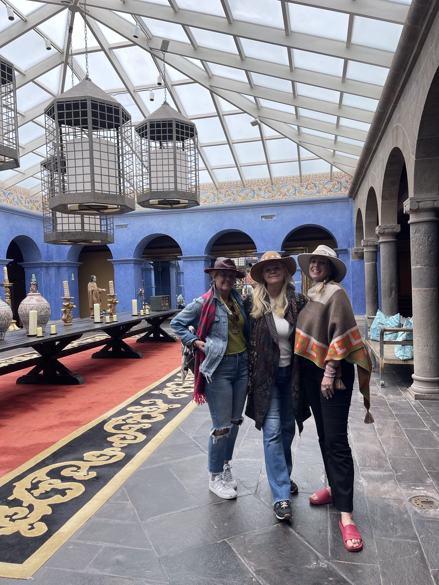 Travelers exploring the Palacio del Inka courtyard in Cusco