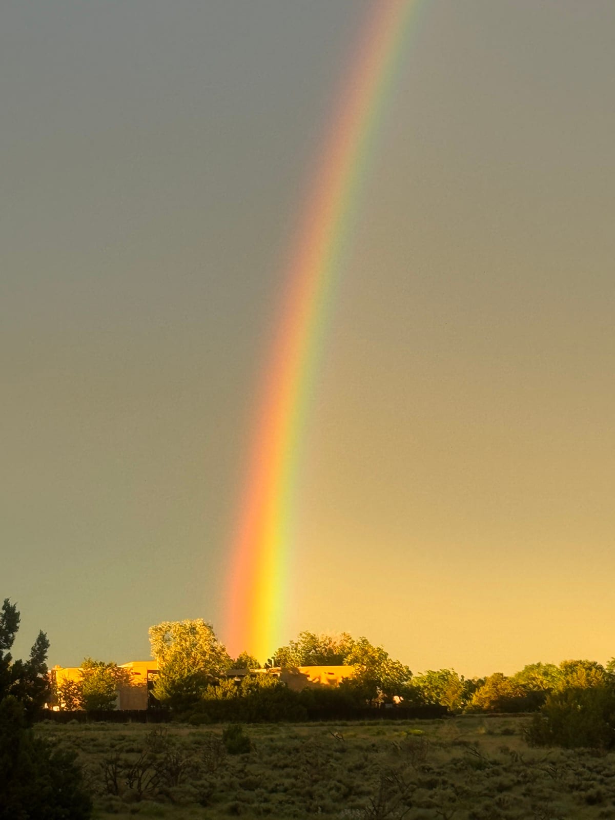 A rainbow over the golden adobe buildings of Santa Fe - Shamanic Trekker